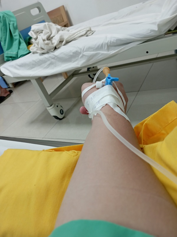 Cảnh truyền nước với tay gác nhẹ trên giường